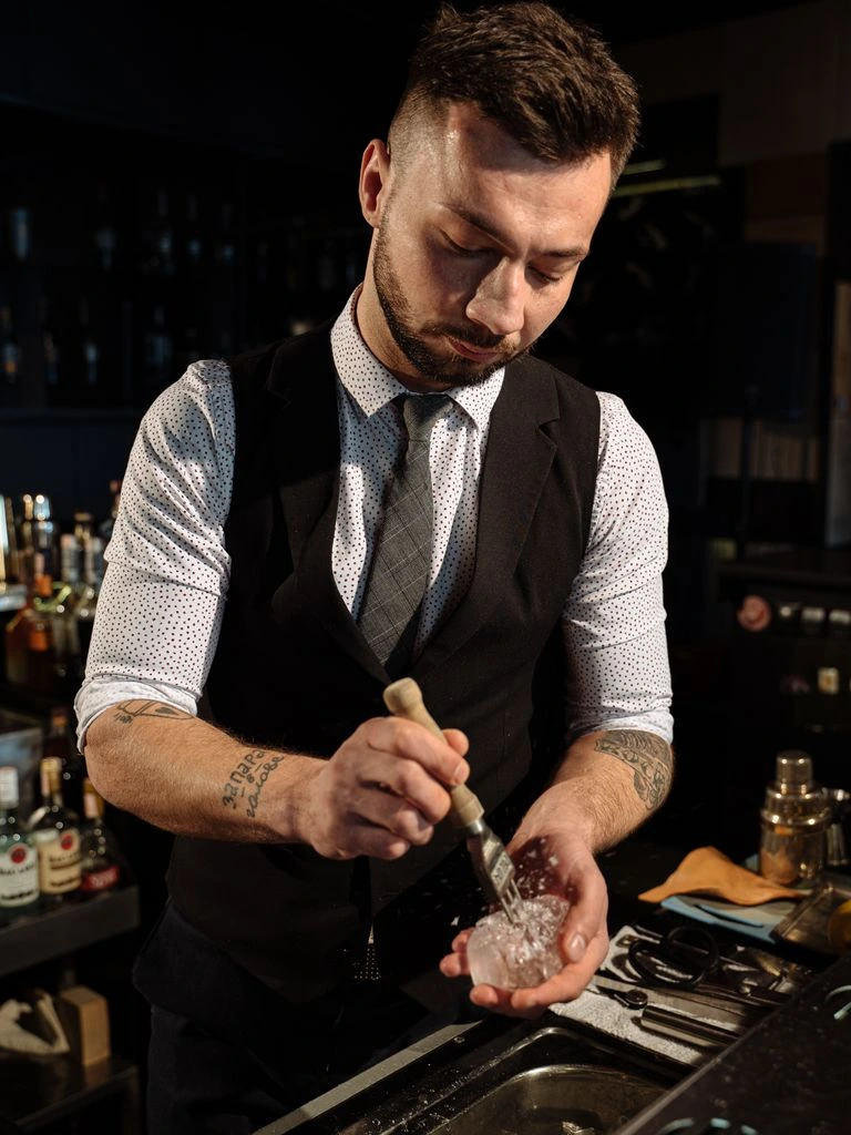 Yaima Rodríguez, head bartender at Timba Social Club, finishing a coupe cocktail at the bar.