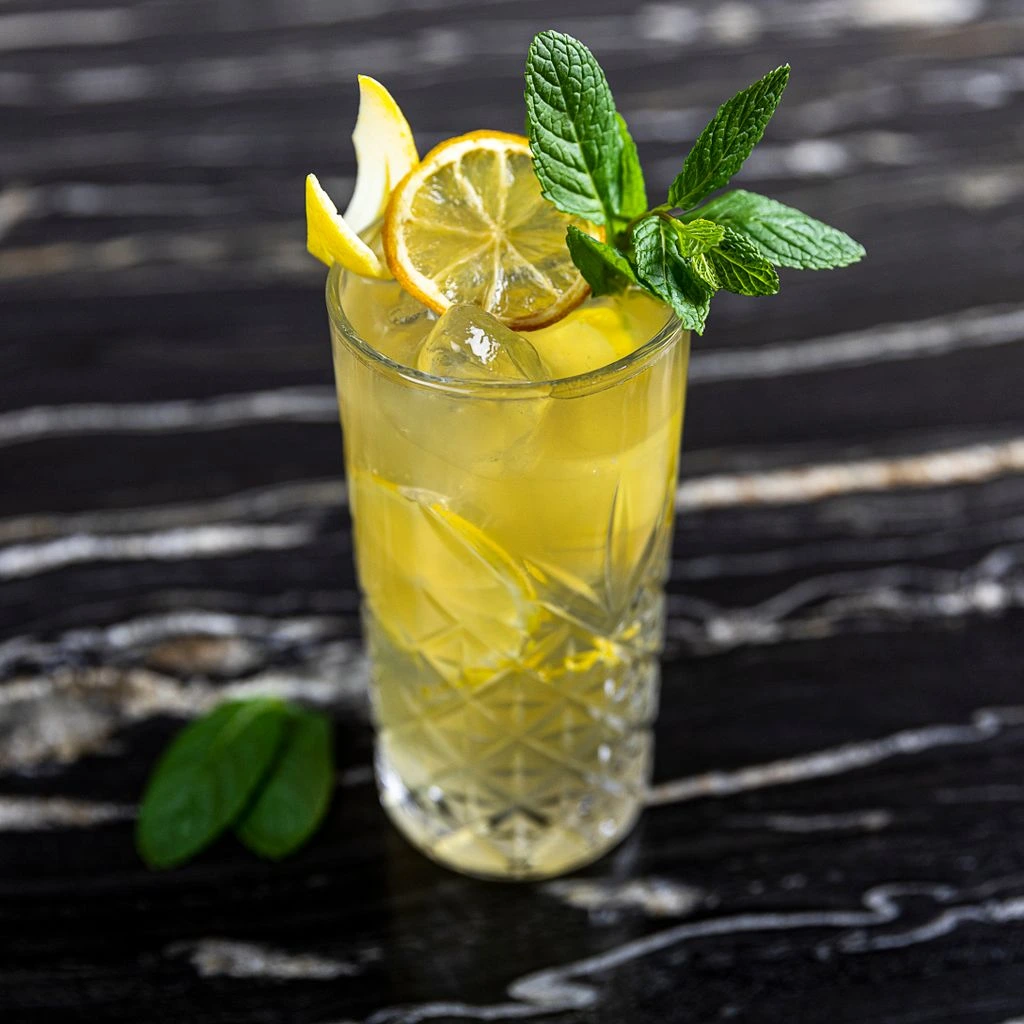 The O'Reilly Highball — mint, lime, white rum — on a brass tray